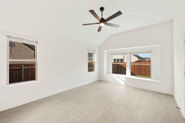 spare room featuring light hardwood / wood-style flooring, ceiling fan, and lofted ceiling