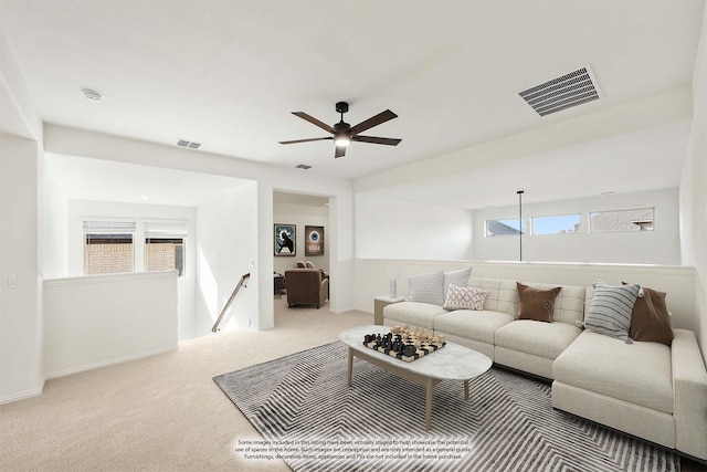 living room with a healthy amount of sunlight, carpet flooring, and ceiling fan