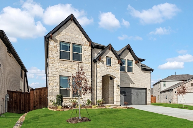 view of front of house featuring a garage and a front lawn