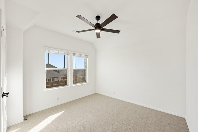 unfurnished room with ceiling fan, light carpet, and vaulted ceiling