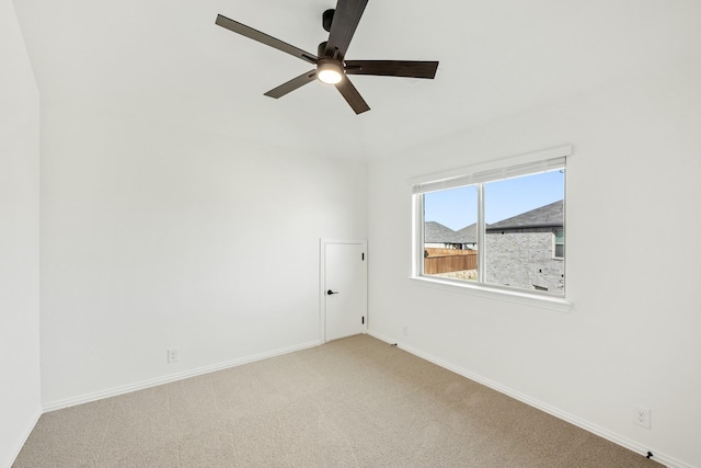 carpeted spare room featuring ceiling fan