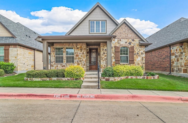 8604 Grassland Dr, Mckinney, TX 75070 - view of front of property featuring stone siding, a porch, and a front yard