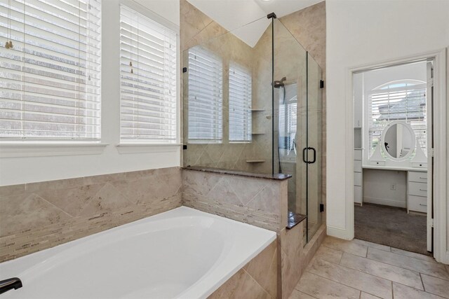 bathroom with tile patterned flooring and plus walk in shower