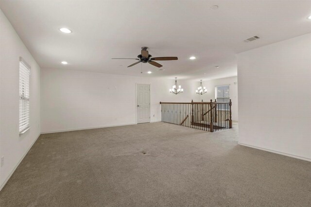 unfurnished living room with carpet and ceiling fan with notable chandelier