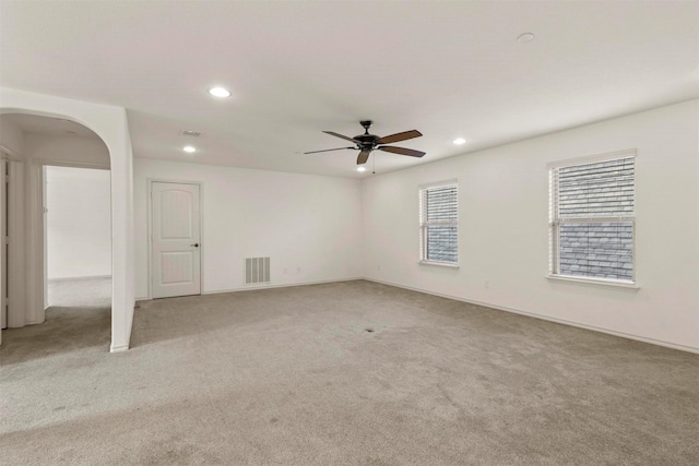 8604 Grassland Dr, Mckinney, TX 75070 - empty room featuring light carpet, recessed lighting, arched walkways, baseboards, and ceiling fan