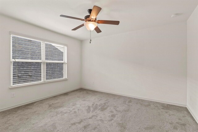 empty room featuring carpet flooring and ceiling fan