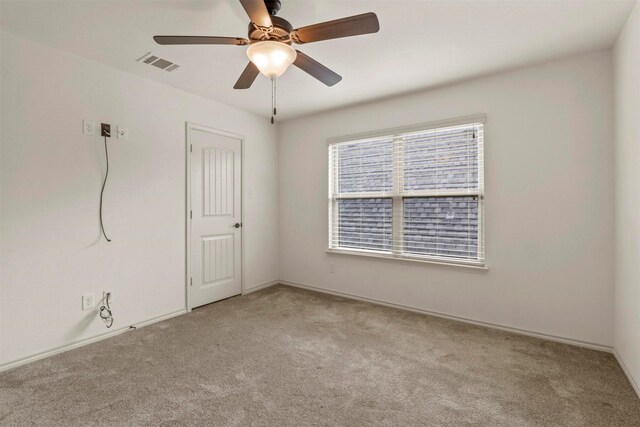 unfurnished room featuring ceiling fan and light colored carpet