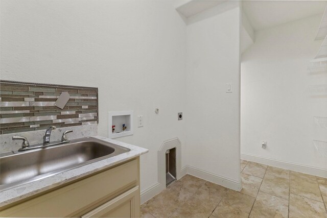 laundry area featuring light tile patterned flooring, sink, hookup for an electric dryer, and washer hookup