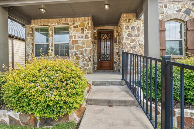 view of exterior entry with a porch