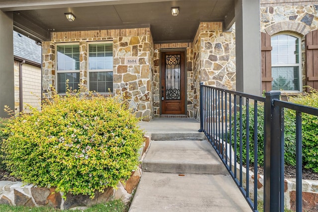 8604 Grassland Dr, Mckinney, TX 75070 - property entrance with stone siding and a porch