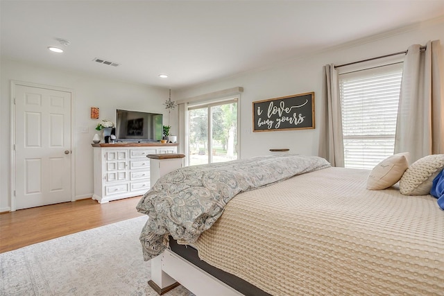 bedroom featuring access to outside, wood finished floors, visible vents, and recessed lighting