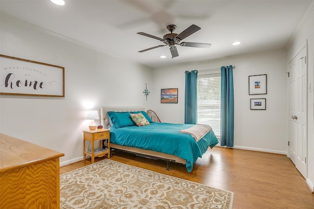 bedroom featuring recessed lighting, wood finished floors, a ceiling fan, baseboards, and ornamental molding