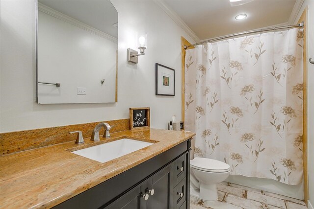 bathroom with tile patterned floors, crown molding, toilet, and vanity