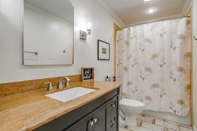 bathroom with ornamental molding, vanity, and toilet