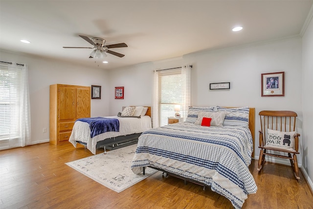 bedroom with crown molding, ceiling fan, and hardwood / wood-style floors