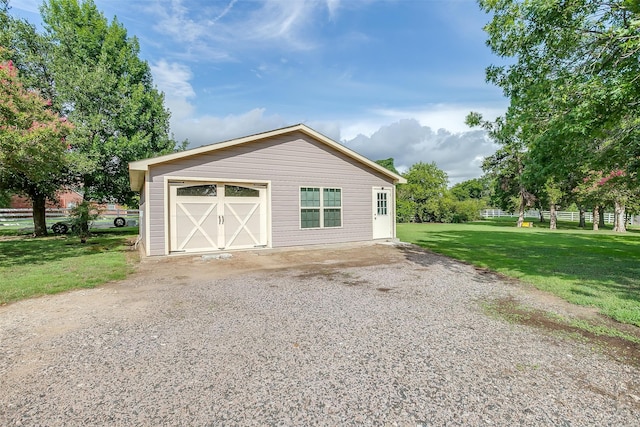 garage featuring a lawn