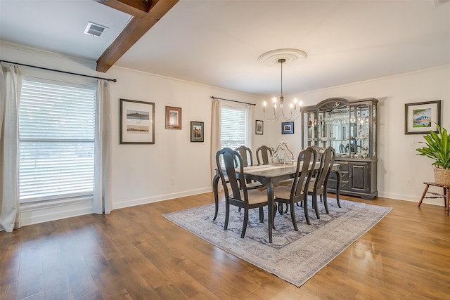 dining area featuring wood-type flooring, a notable chandelier, and beam ceiling