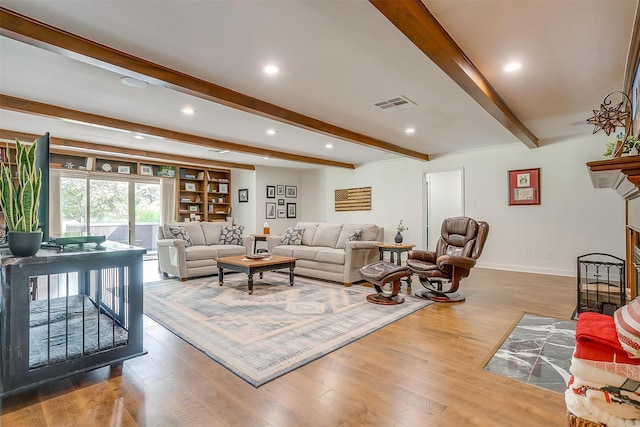 living room featuring hardwood / wood-style floors and beam ceiling