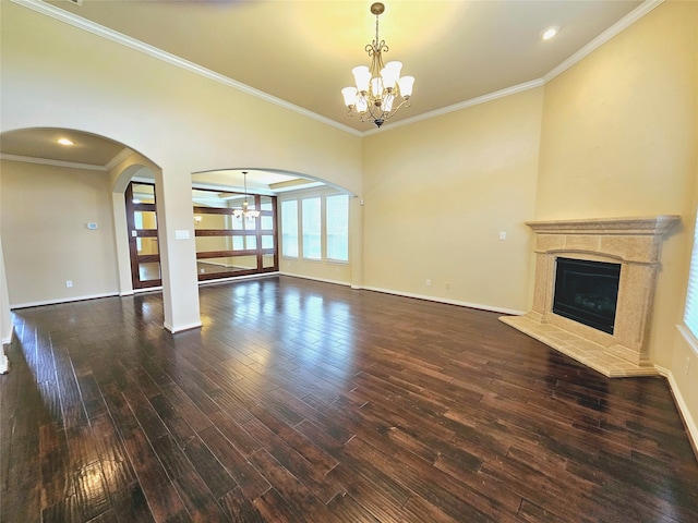 unfurnished living room featuring hardwood / wood-style flooring, ceiling fan with notable chandelier, and ornamental molding