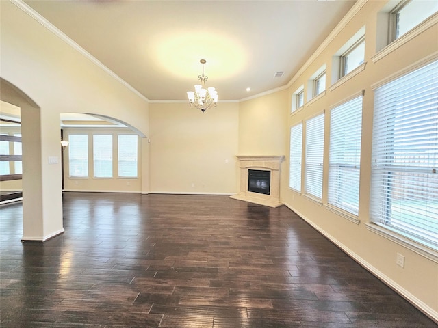 14229 Alis Ln, Frisco, TX 75035 - unfurnished living room with a chandelier, dark wood-style floors, a wealth of natural light, and ornamental molding