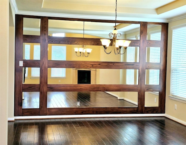14229 Alis Ln, Frisco, TX 75035 - unfurnished dining area featuring a tray ceiling, crown molding, baseboards, a chandelier, and dark wood-style flooring