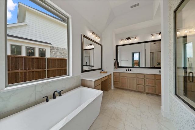 bathroom with tile patterned flooring, lofted ceiling, separate shower and tub, and plenty of natural light