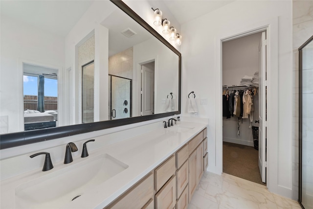 bathroom with tile patterned floors, an enclosed shower, and dual bowl vanity