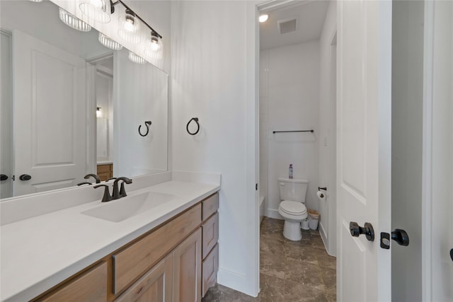 bathroom featuring tile patterned floors, vanity, and toilet