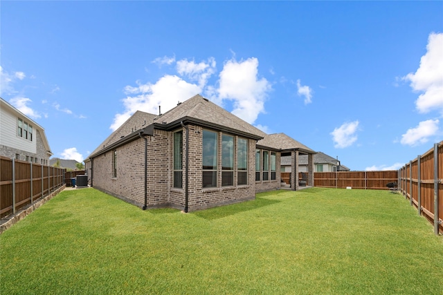 rear view of house featuring a yard