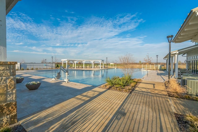 view of pool with a pergola, a patio, and central air condition unit