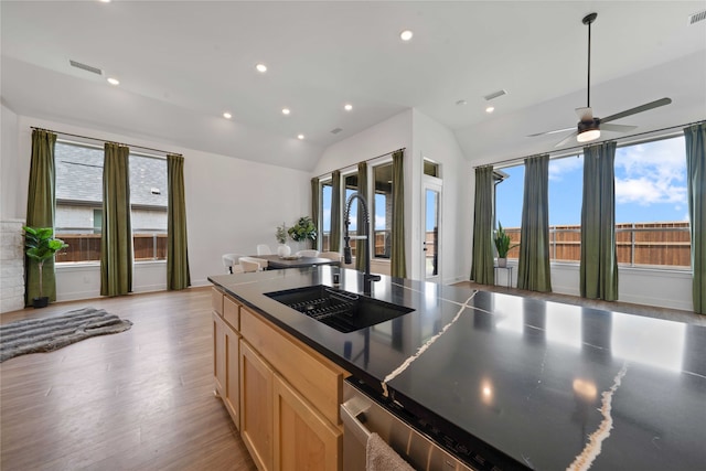 kitchen featuring ceiling fan, light brown cabinets, sink, light hardwood / wood-style floors, and lofted ceiling