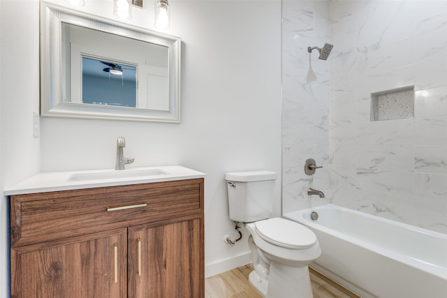 full bathroom with toilet, hardwood / wood-style floors, vanity, and tiled shower / bath