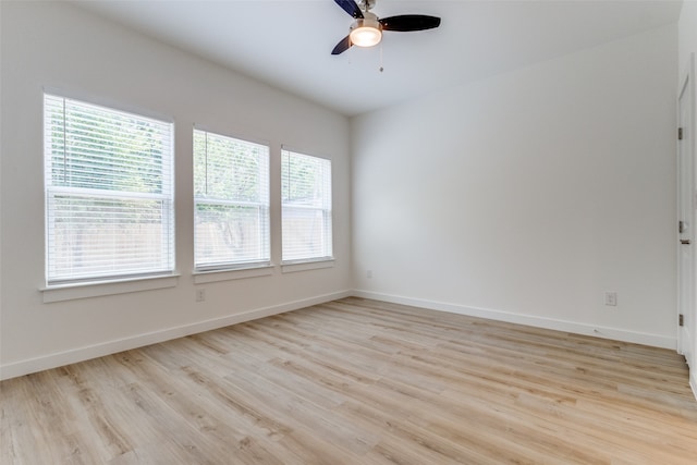 empty room with ceiling fan, light hardwood / wood-style flooring, and a healthy amount of sunlight