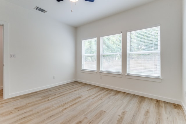 spare room featuring plenty of natural light, light wood-type flooring, and ceiling fan