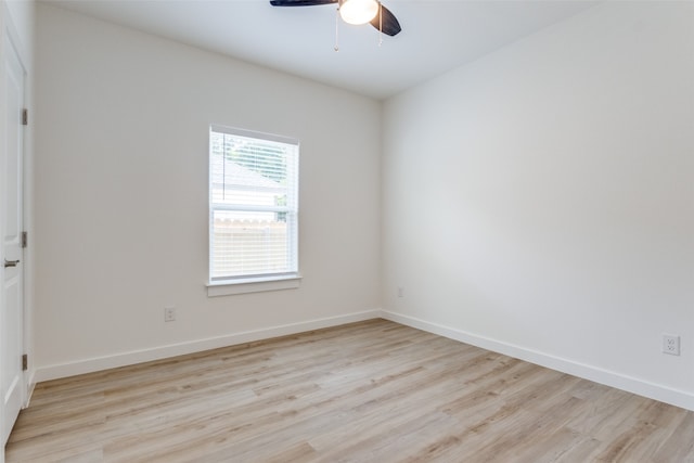 spare room featuring light hardwood / wood-style flooring and ceiling fan