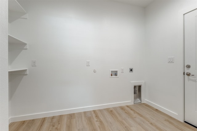 laundry room with hookup for a washing machine, light hardwood / wood-style floors, hookup for an electric dryer, and hookup for a gas dryer