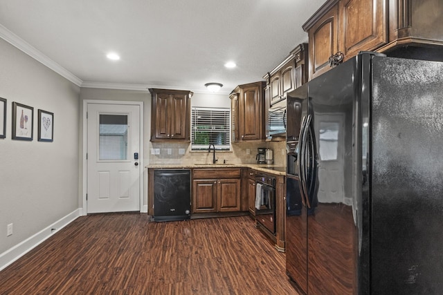 kitchen featuring sink, crown molding, dark hardwood / wood-style floors, black appliances, and decorative backsplash