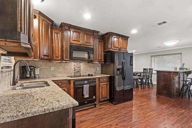 kitchen with crown molding, backsplash, dark hardwood / wood-style floors, black appliances, and sink