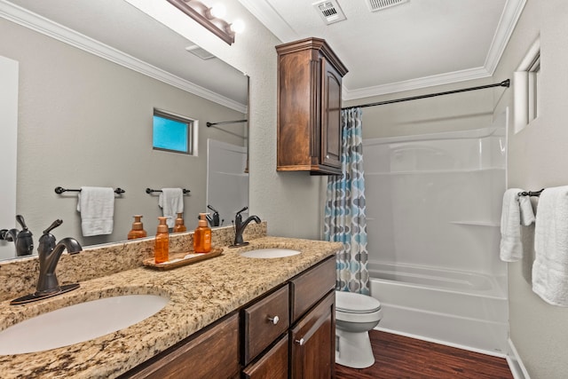 full bathroom with crown molding, dual bowl vanity, toilet, shower / bath combo, and hardwood / wood-style floors