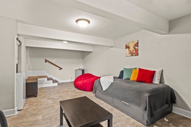 bedroom with washer / dryer, a textured ceiling, and light tile patterned flooring