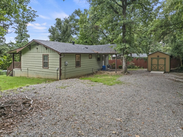 back of property featuring a storage shed