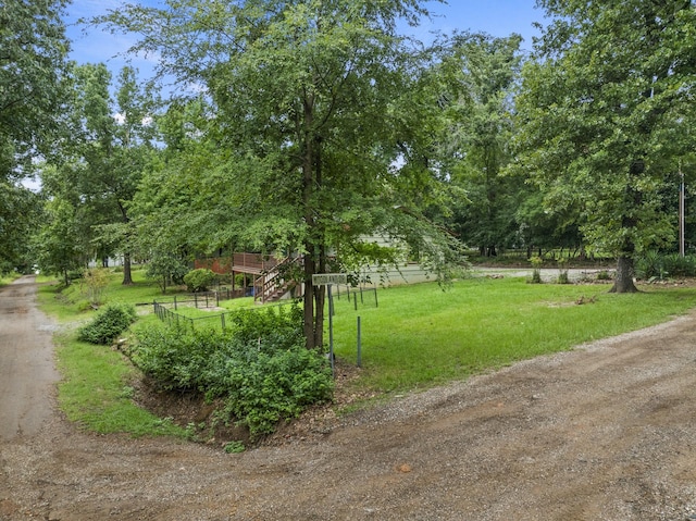 view of community featuring a lawn and a rural view