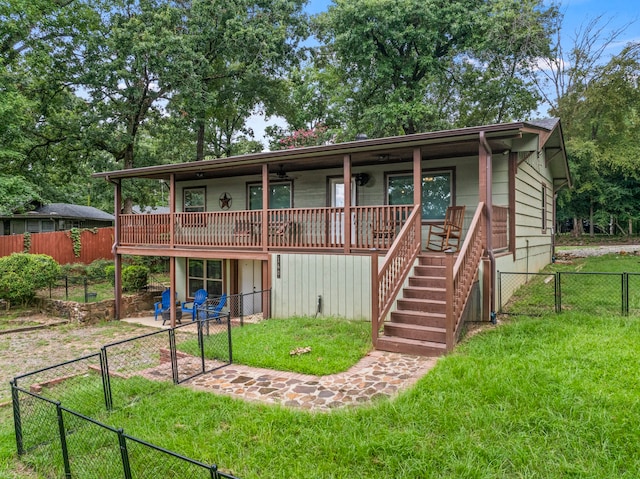 view of front facade featuring a deck and a front yard