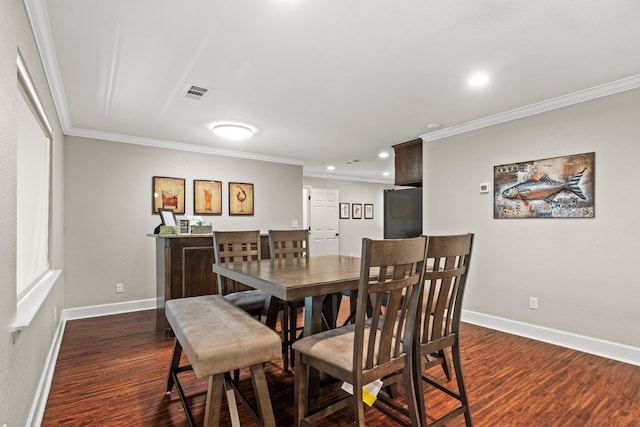 dining area featuring crown molding and dark hardwood / wood-style floors