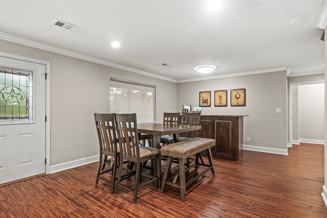 dining area with wood-type flooring and ornamental molding