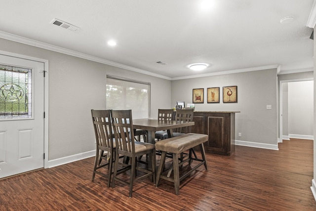 dining area featuring dark wood-type flooring and ornamental molding