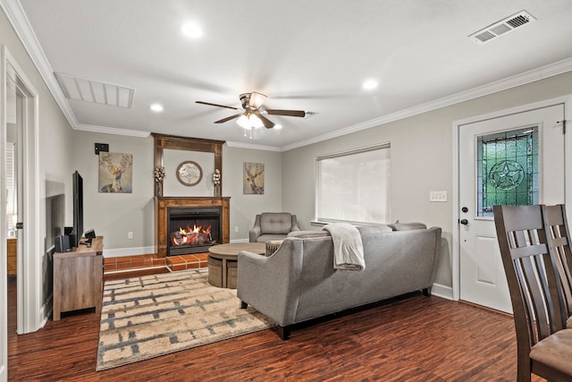 living room featuring ceiling fan, dark hardwood / wood-style flooring, and ornamental molding