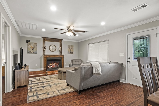 living room featuring crown molding, dark wood-type flooring, and ceiling fan