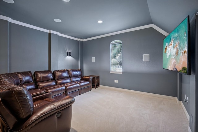 home theater room featuring light carpet, vaulted ceiling, and ornamental molding