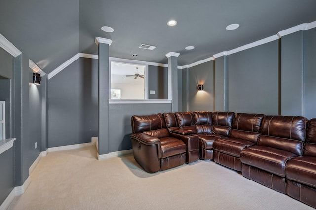 cinema with ornate columns, crown molding, light carpet, and ceiling fan